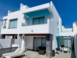 a white house with a balcony and a patio at Luxury Villa in Los Cristianos in Arona