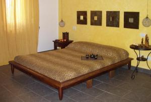 a bed in a room with two tables in a room at Le Pozze Terme B&B in Viterbo