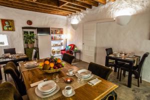 a dining room with a table with a bowl of fruit on it at Los Lirios Hotel Rural - Adults Only in Tías