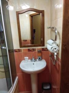 a bathroom with a sink and a mirror at Khorol-1 Motel in Khorol