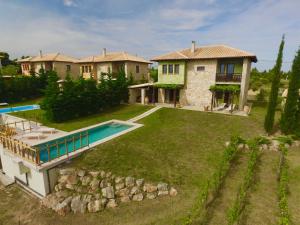 an aerial view of a house with a swimming pool at Fruit Garden Villas in Kriopigi