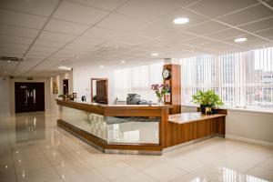 a lobby with a reception desk in a building at Milton Manchester Hotel in Manchester