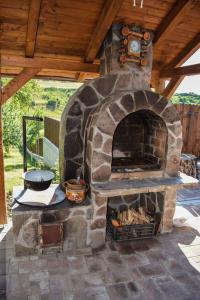 a stone oven with a clock on top of it at Pensiunea Bogas in Praid