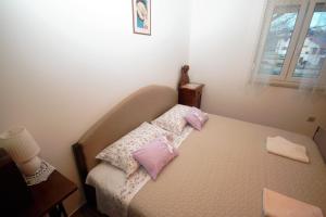Postel nebo postele na pokoji v ubytování Apartments Cvelic Milovcic