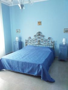 een blauwe slaapkamer met een bed en twee nachtkastjes bij La Montecchia House in Montecchia di Crosara