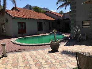 a swimming pool in the backyard of a house at Gracious Lodge in Burgersfort