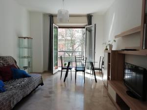 a living room with a couch and a table and chairs at Staurenghi34apartmenT in Varese