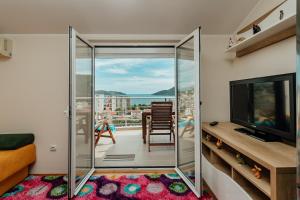 a living room with a glass door leading to a balcony at Boka View in Igalo