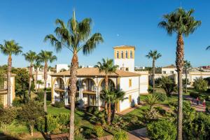 an aerial view of a mansion with palm trees at Aldiana Club Andalusien in Chiclana de la Frontera