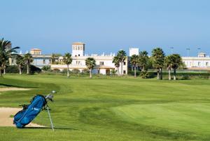 a golf course with a blue bag on the green at Aldiana Club Andalusien in Chiclana de la Frontera