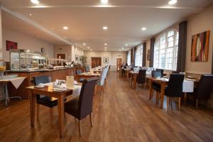 a restaurant with wooden tables and chairs and a bar at The Management Centre in Bangor