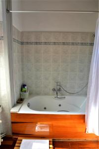 a bath tub with a sink in a bathroom at V. Molova, Molyvos, Lesvos in Mithymna