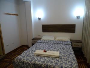 A bed or beds in a room at Peruvian Family Hostal Miraflores