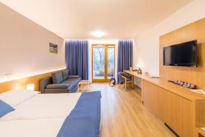 Postel nebo postele na pokoji v ubytování Hotel Kaskáda