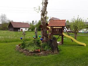 a playground in a yard with a slide at Russhof-Fam.Thomann in Stainz
