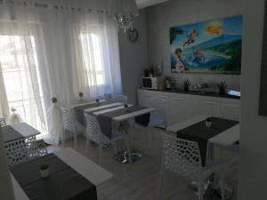 a kitchen with tables and chairs in a room at B&B Il Mare degli Dei in Letojanni
