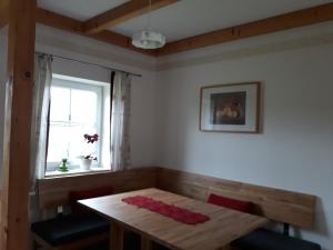 a dining room with a table and a window at Russhof-Fam.Thomann in Stainz