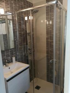 a bathroom with a glass shower and a sink at B&B Il Mare degli Dei in Letojanni