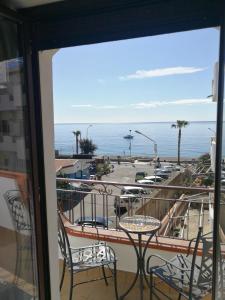 a balcony with a table and chairs and the ocean at B&B Il Mare degli Dei in Letojanni