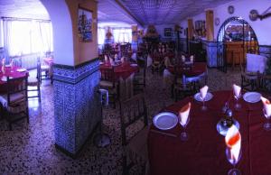 an overhead view of a restaurant with red tables and chairs at Pensión Provenzal in Mojácar