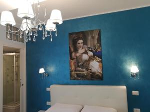 a room with a painting of a woman on the wall at B&B Il Mare degli Dei in Letojanni