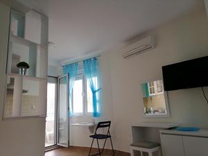 a living room with a chair and a window at Apartment Stella Maris in Herceg-Novi