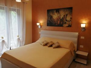a bedroom with a bed with two pillows on it at B&B Il Mare degli Dei in Letojanni