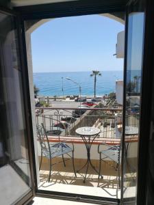 a view of a balcony with tables and chairs at B&B Il Mare degli Dei in Letojanni