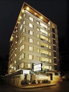 a tall building with lights on top of it at iCheck inn Residence soi 2 in Bangkok