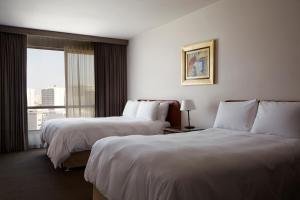 Llit o llits en una habitació de BTH Hotel Lima Golf