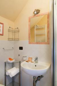 a bathroom with a sink and a mirror at Agriturismo Il Castagnolino in San Gimignano