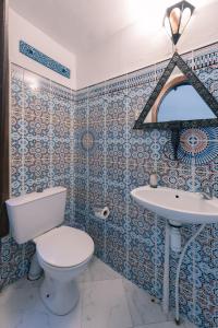 a bathroom with a toilet and a sink at Riad Dar Nawfal in Salé