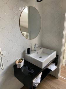 y baño con lavabo y espejo. en Residence Cavour 63, en Rávena