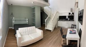 a living room with a white couch and a table at Residence Cavour 63 in Ravenna