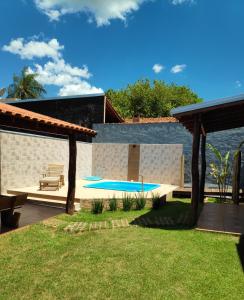 un patio trasero con piscina y banco en RANCHO DA PISCINA EM BONITO, en Bonito