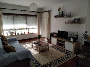 a living room with a couch and a coffee table at Rota das praias in Figueira da Foz