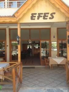 a building with a sign that says eggs on it at Hotel Efes in Gumuldur