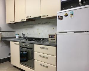 a kitchen with a stove and a white refrigerator at La casetta di Monterosso in Monterosso al Mare