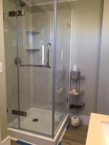a shower with a glass door in a bathroom at Seafarer Inn in Rockport