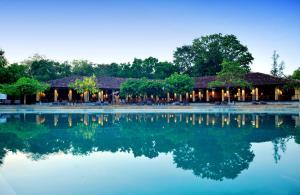 a resort with a large body of water at Habarana Village by Cinnamon in Sigiriya