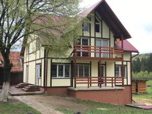 a large house with a balcony on the side of it at Шале на зарінку in Izki