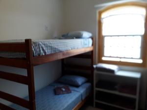 two bunk beds in a room with a window at Casarão do DU in Campinas +125 photos