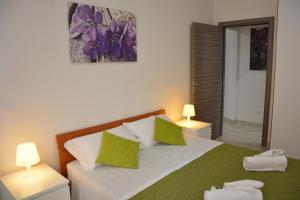 A bed or beds in a room at Green Residence