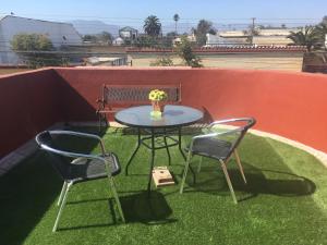 a patio table and two chairs on a roof at Residencial Campo Verde in La Serena