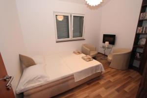 a white bedroom with a bed and a window at Bungalow 4 Suns in Virpazar +22 photos