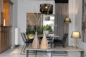 a living room with a table with two vases on it at Cretan Luxury Villa by Smaris Collection in Kokkíni Khánion