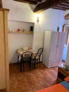 a dining room with a table and chairs and a cabinet at Centro mini monolocale in Poggibonsi