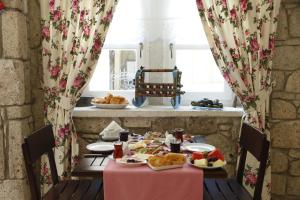 a table with food on it in a room at Ciftekuyu Hotel in Alaçatı