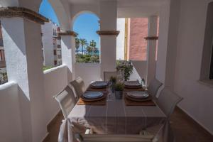 a dining room table and chairs with a view of the ocean at Atlanterra Sol in Zahara de los Atunes