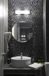 a bathroom with a sink and a mirror at CROSS PLAZA in Stavros